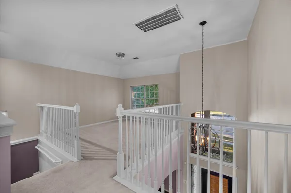 a view of an empty room with stairs