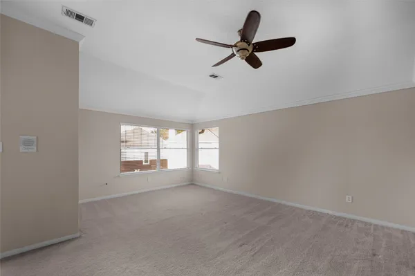 a view of a livingroom with a ceiling fan and window
