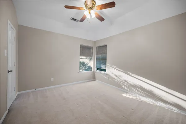 a view of a room with window and ceiling fan