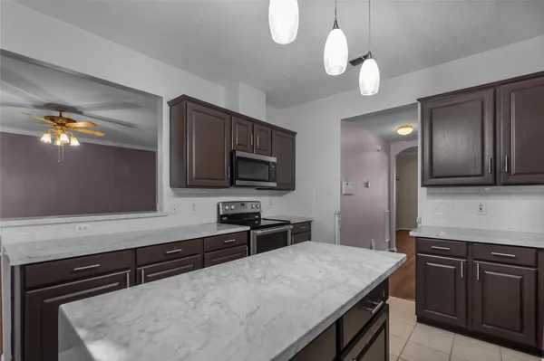 a kitchen with a stove microwave and sink