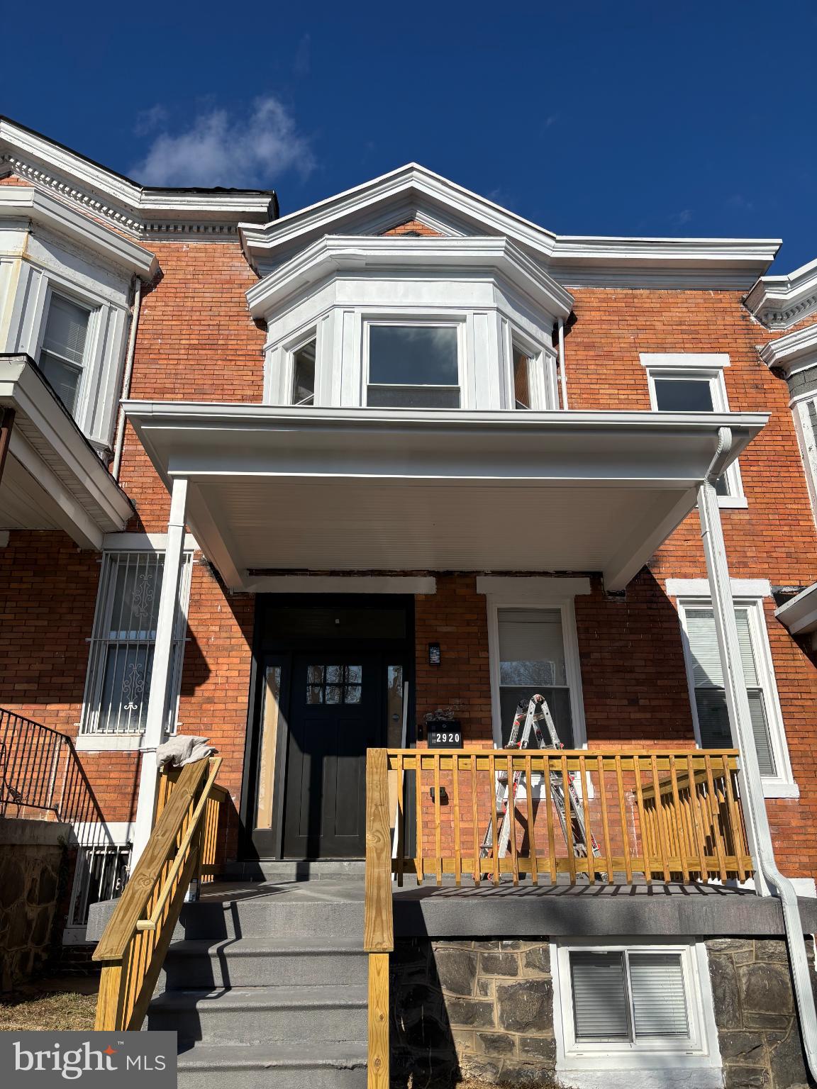 Charming brick facade with inviting porch.