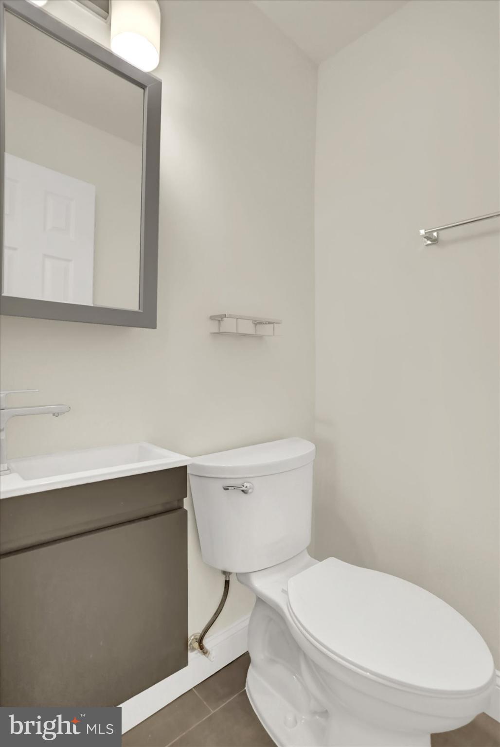 2920 Brighton Street Baltimore, MD 21216 - Photo 14 of 32 a white toilet sitting next to a bathroom sink