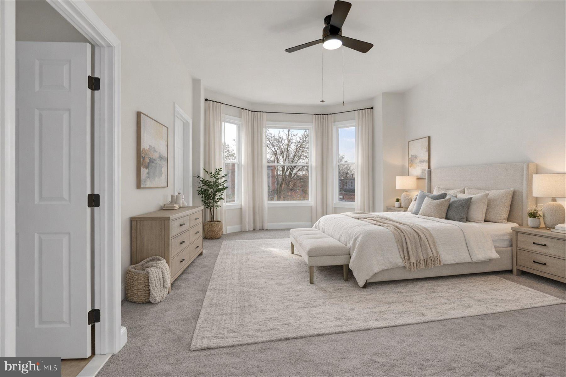 2920 Brighton Street Baltimore, MD 21216 - Photo 16 of 32 a spacious bedroom with a bed and glass window