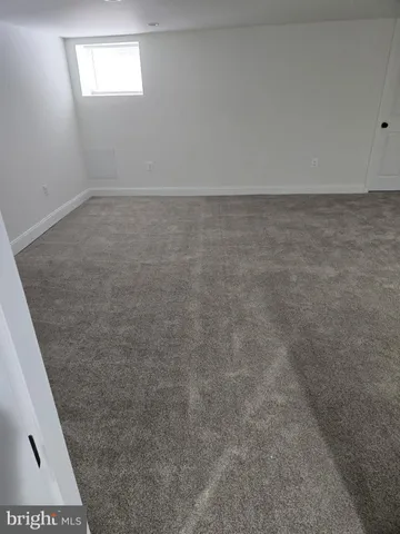 a view of empty room with wooden walls