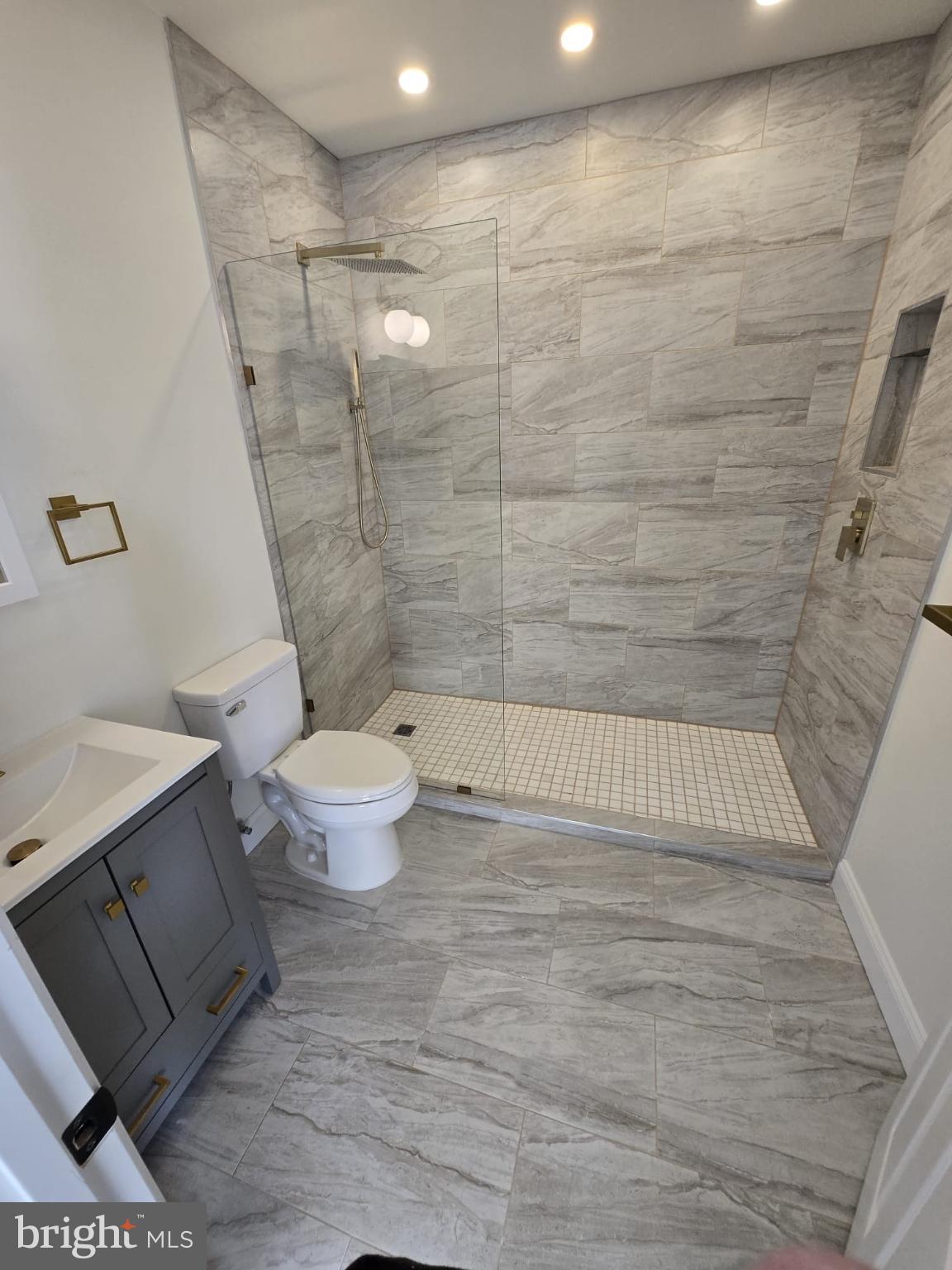 2920 Brighton Street Baltimore, MD 21216 - Photo 18 of 32 a bathroom with a toilet and a shower