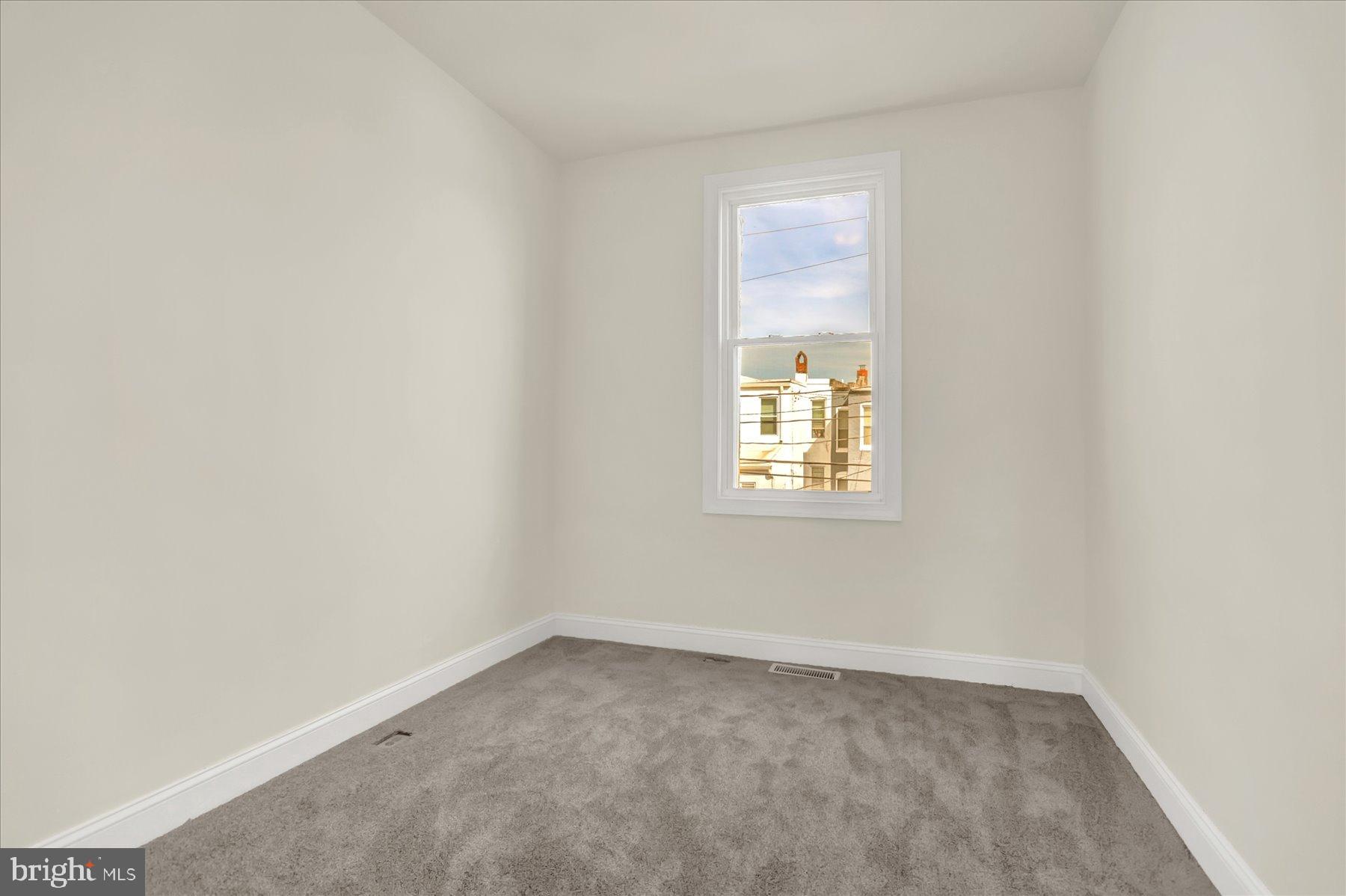 2920 Brighton Street Baltimore, MD 21216 - Photo 22 of 32 an empty room with a window