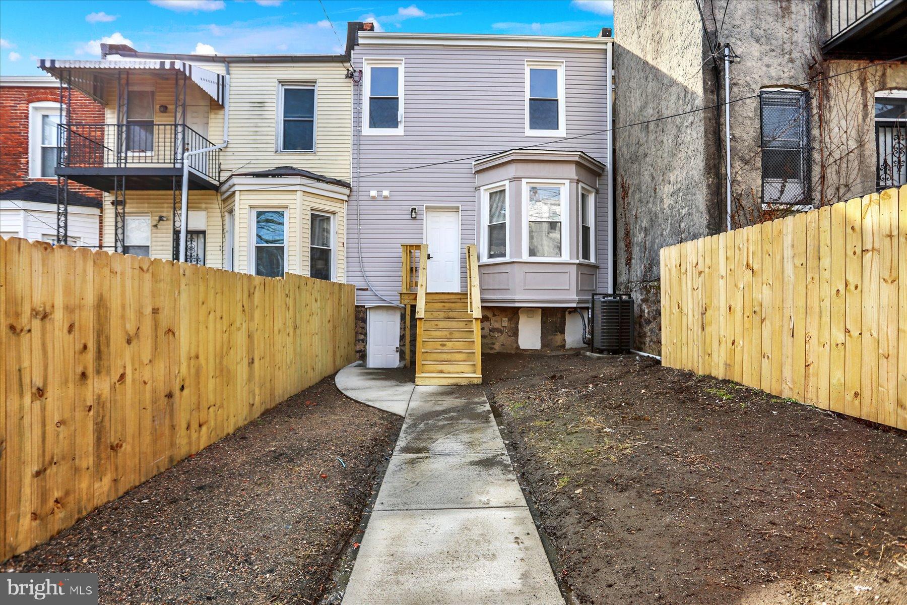 2920 Brighton Street Baltimore, MD 21216 - Photo 31 of 32 a view of a brick house with many windows