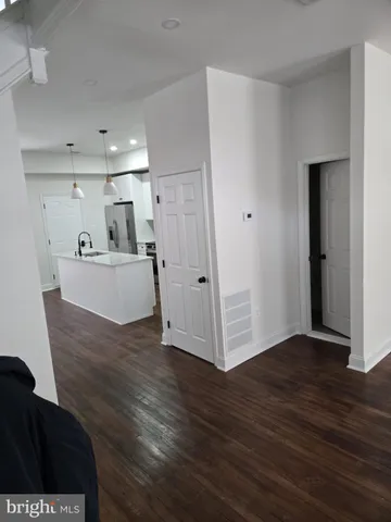 a view of a kitchen with wooden floor