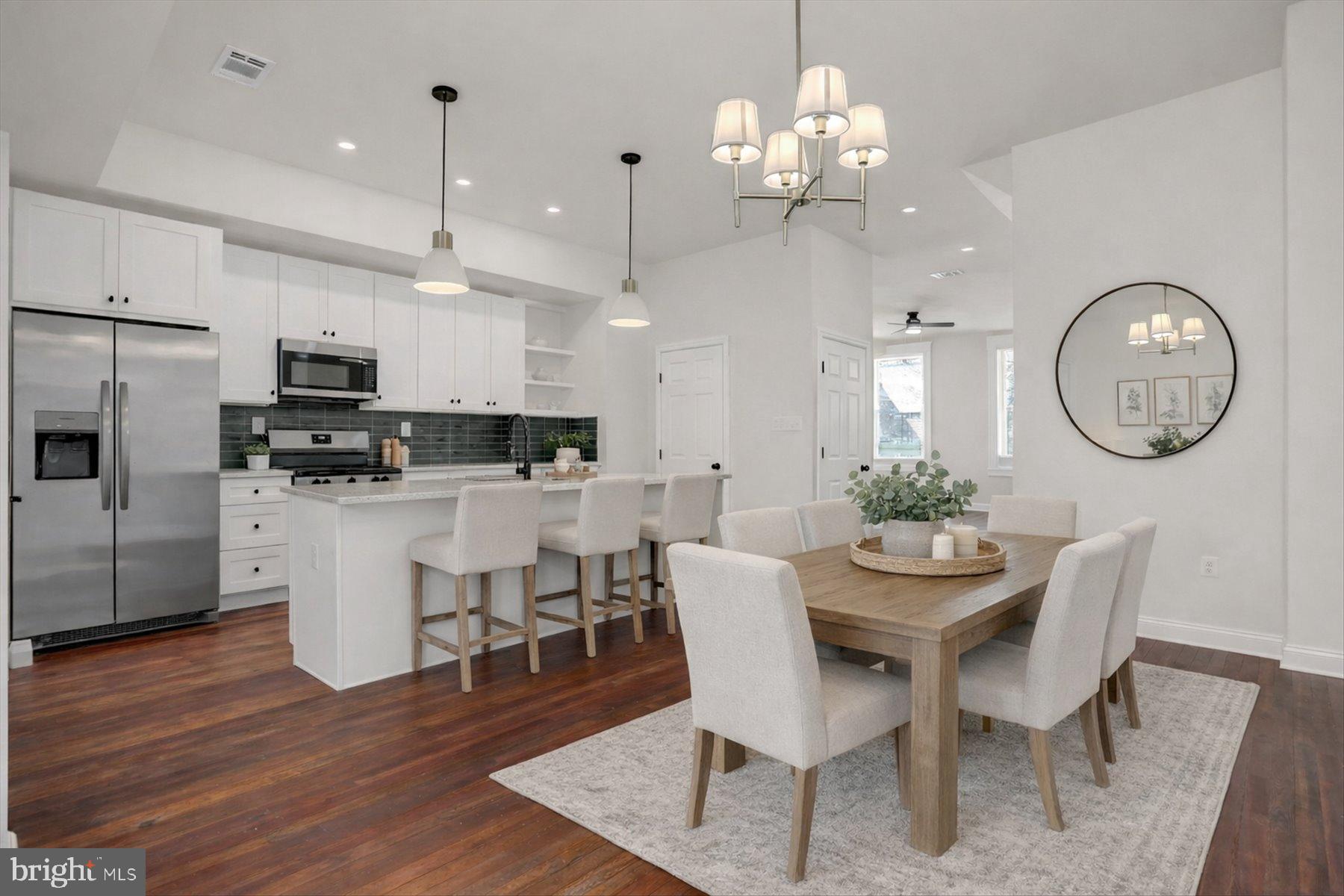 2920 Brighton Street Baltimore, MD 21216 - Photo 10 of 32 a view of a dining room with furniture a kitchen chandelier and kitchen view
