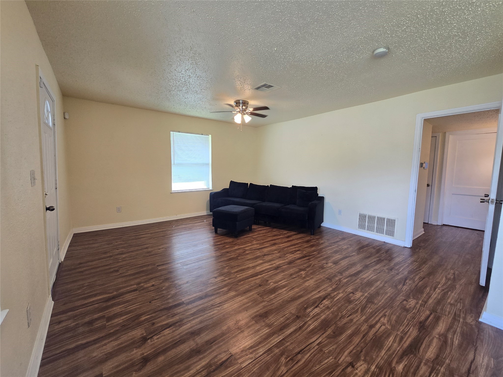 5218 Kelso Street Houston, TX 77021 - Photo 4 of 7 a living room with hard wood floors and a ceiling fan