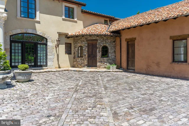 a view of a house with a yard and furniture