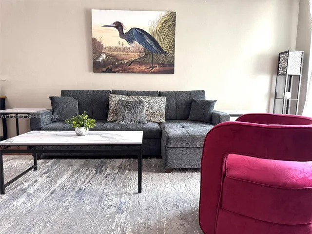 a living room with furniture and a rug