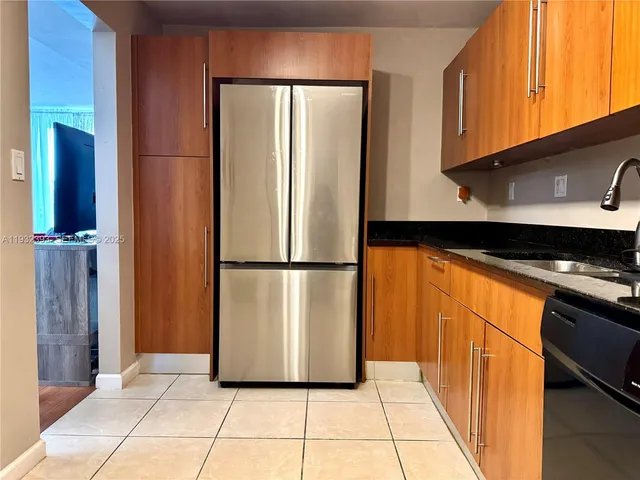 a kitchen with a refrigerator and a stove