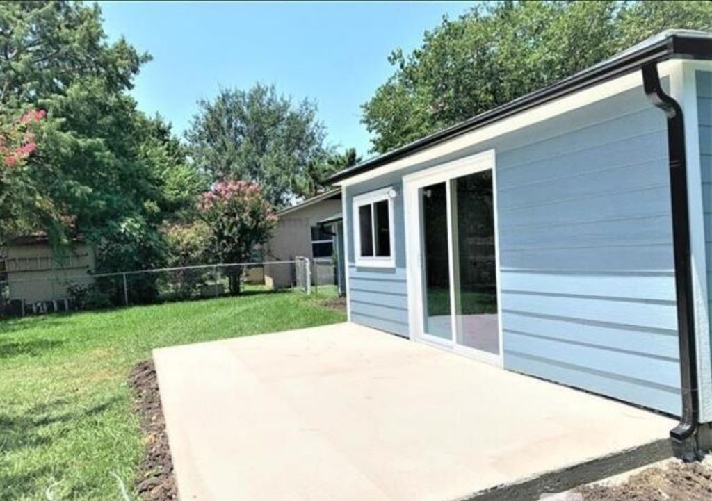 2536 Rutherford Street Irving, TX 75062 - Photo 19 of 19 Newly poured concrete patio featuring a sliding glass door and light blue horizontal siding