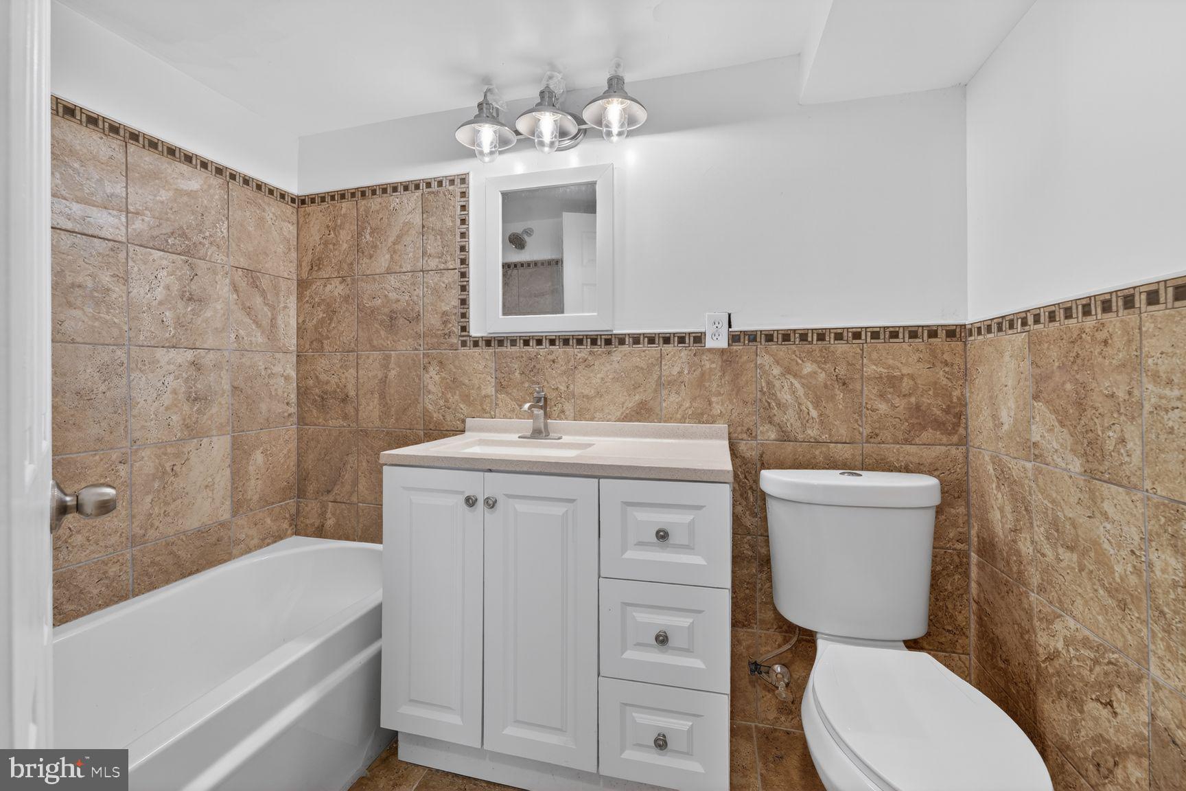 7205 Livingston Road Oxon Hill, MD 20745 - Photo 23 of 25 Modern bathroom with elegant tiles.