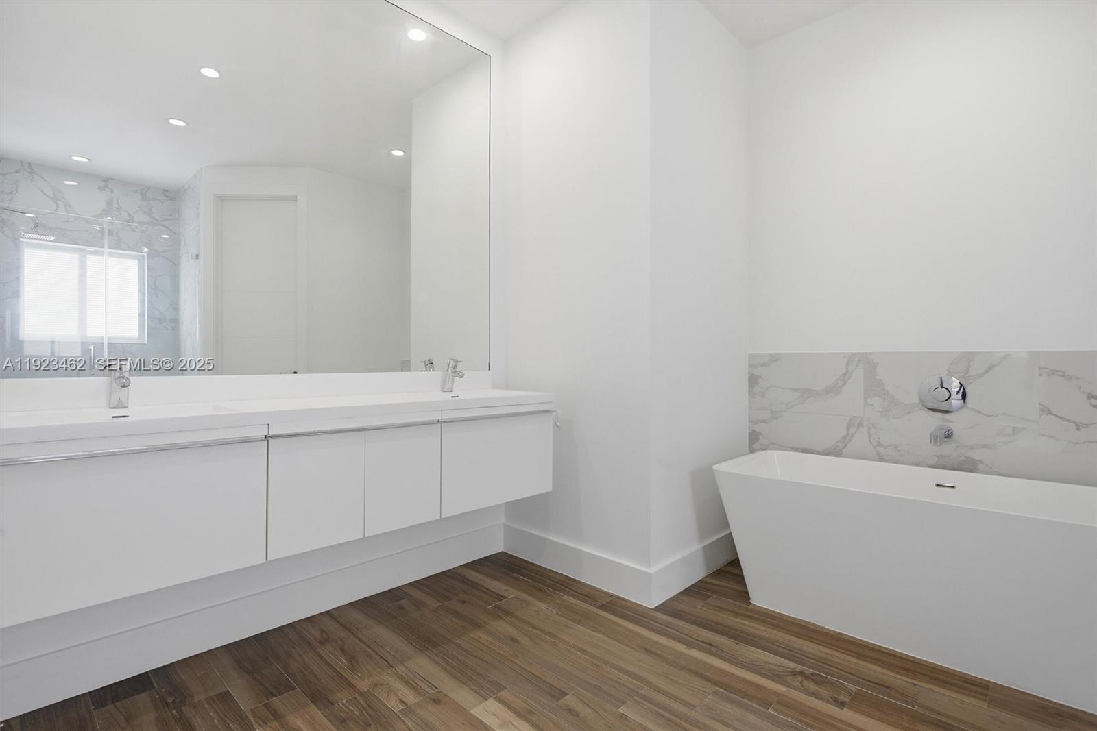 2852 Southwest 32nd Court, Unit 2852 Miami, FL 33133 - Photo 26 of 50 a bathroom with a sink and a mirror