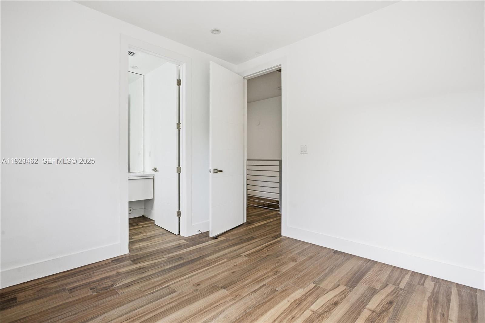 2852 Southwest 32nd Court, Unit 2852 Miami, FL 33133 - Photo 32 of 50 a view of an empty room with wooden floor