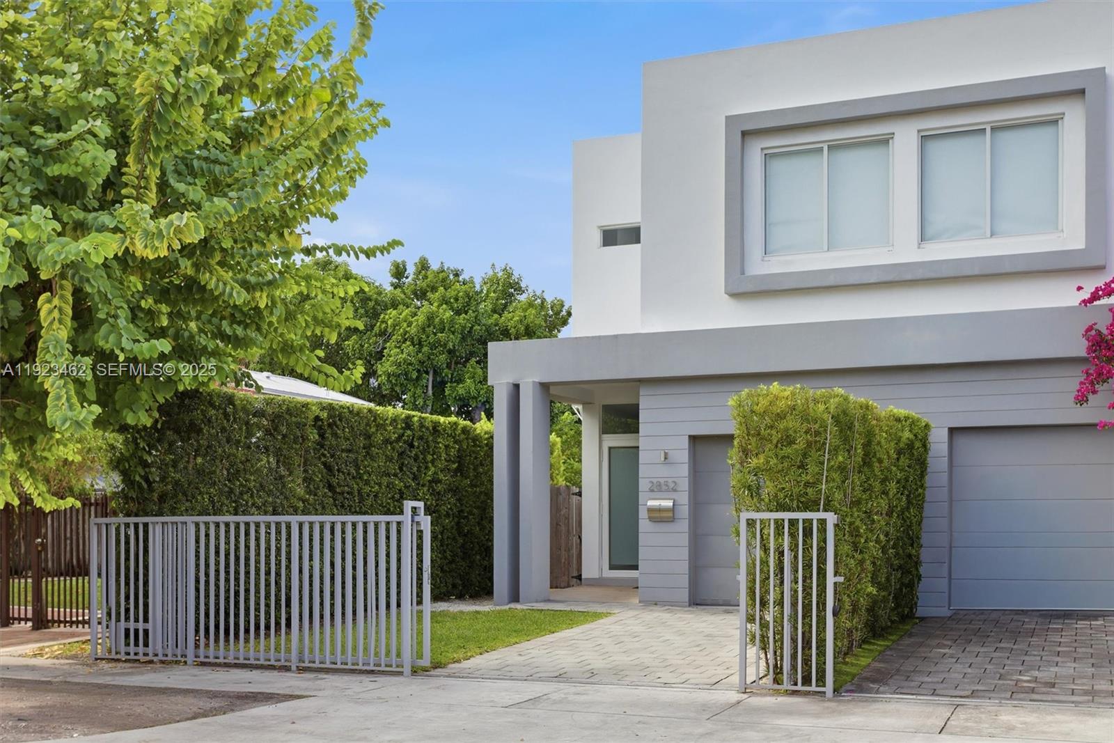 2852 Southwest 32nd Court, Unit 2852 Miami, FL 33133 - Photo 6 of 50 a front view of a house with a garden