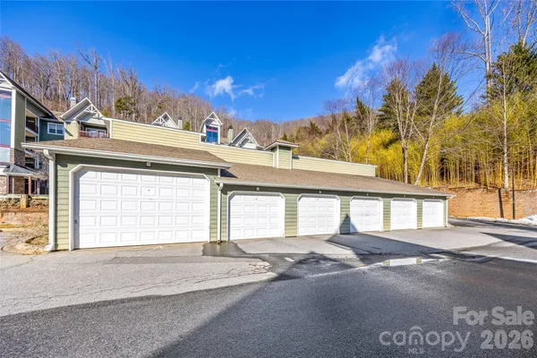 a view of a house with a road and a yard