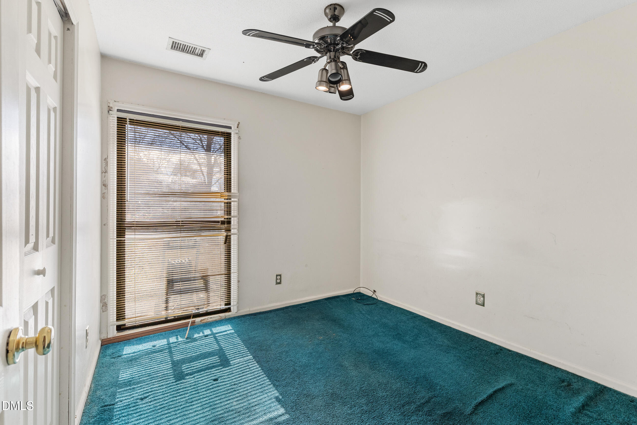 159 Hazel Drive Burlington, NC 27217 - Photo 19 of 21 a view of an empty room with closet and a ceiling fan