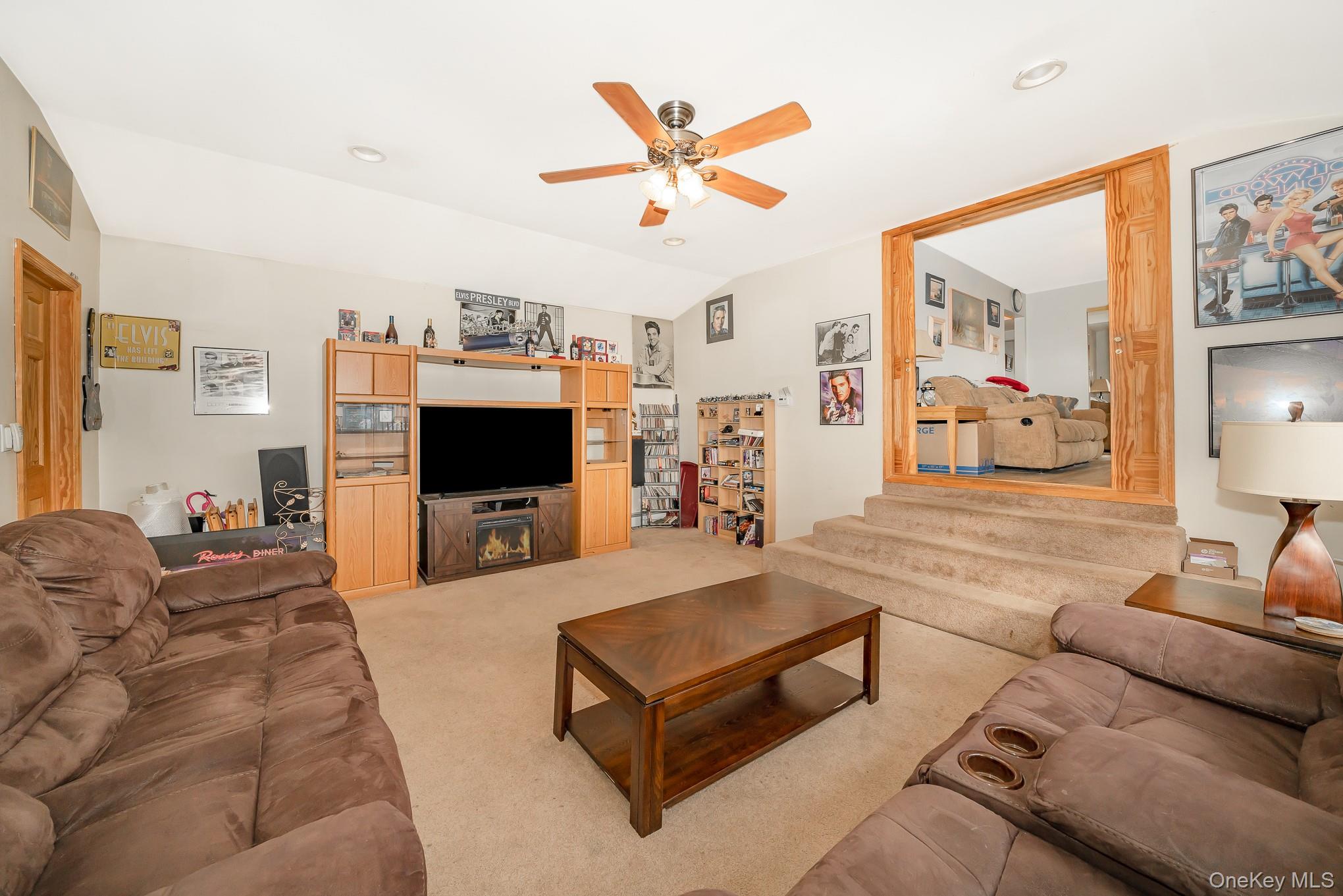 3683 Hawk Road Levittown, NY 11756 - Photo 13 of 41 a living room with furniture and a flat screen tv