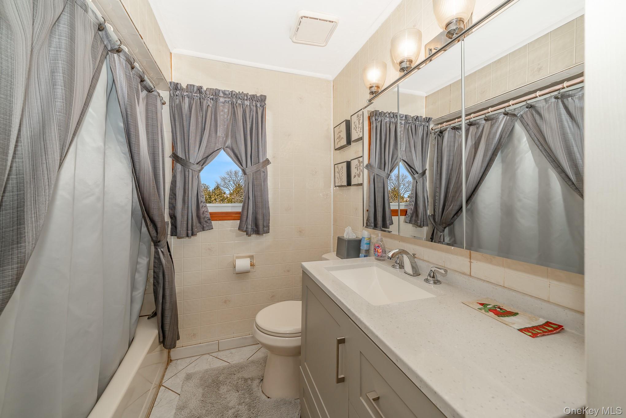 3683 Hawk Road Levittown, NY 11756 - Photo 14 of 41 a bathroom with a sink toilet and shower