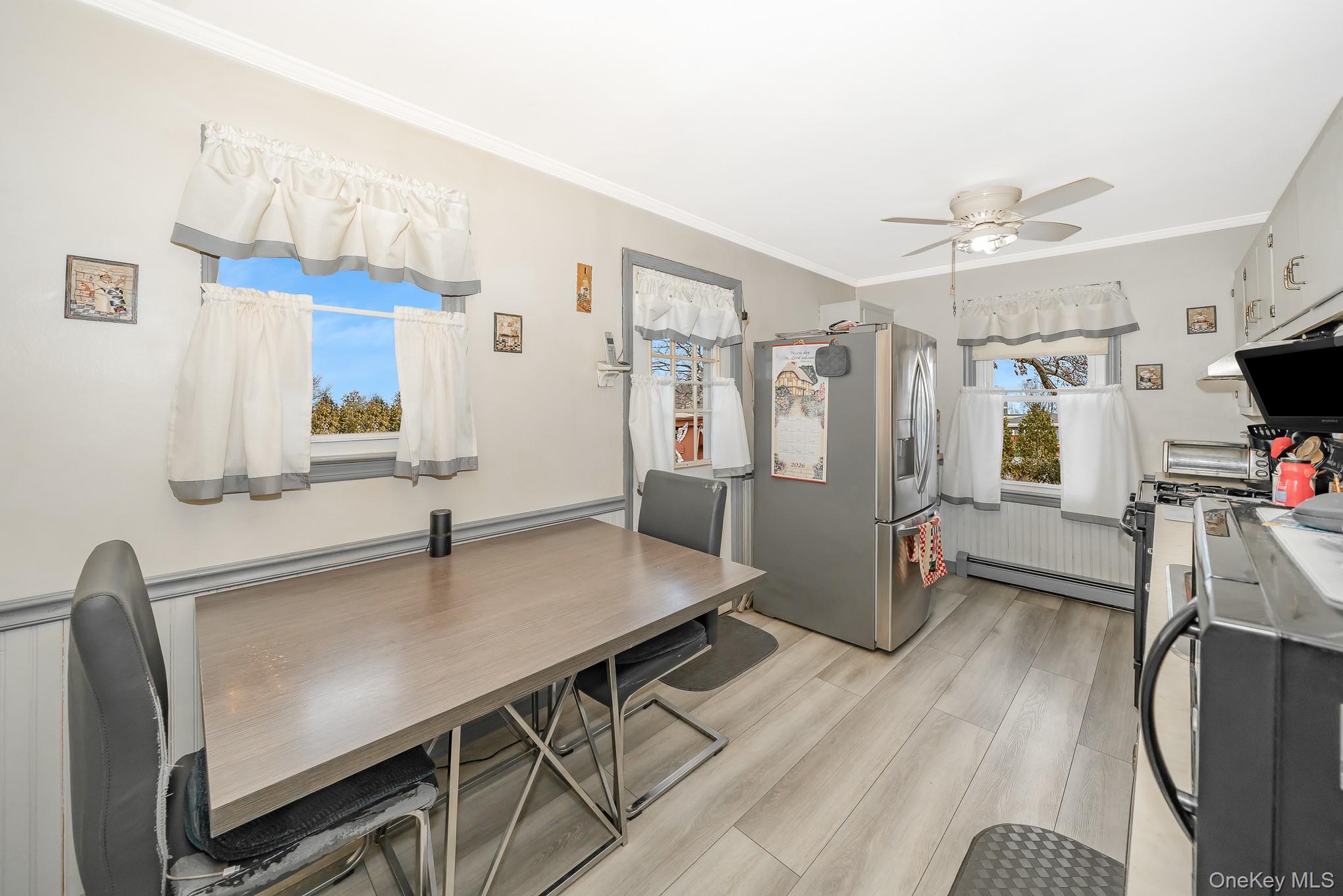 3683 Hawk Road Levittown, NY 11756 - Photo 15 of 41 a living room with furniture a flat screen tv and a wooden floor