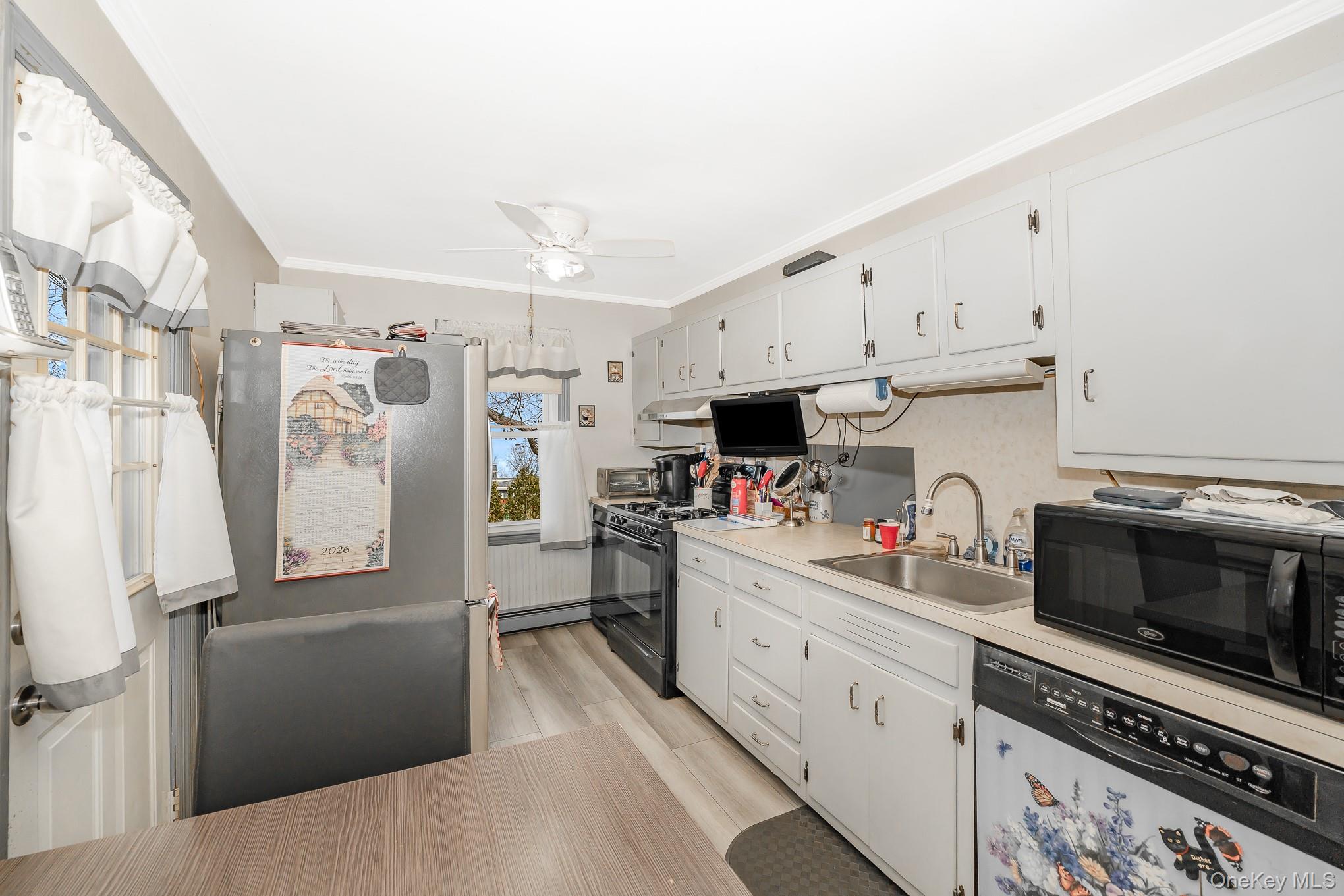 3683 Hawk Road Levittown, NY 11756 - Photo 16 of 41 a kitchen with stainless steel appliances a refrigerator sink and cabinets