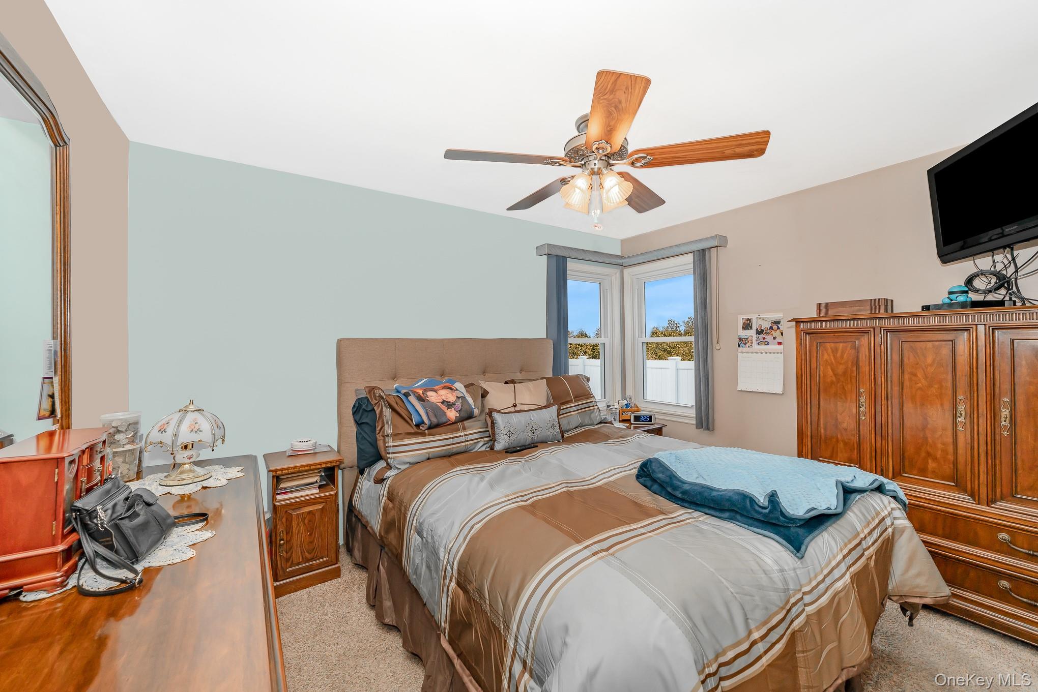 3683 Hawk Road Levittown, NY 11756 - Photo 18 of 41 a bedroom with a bed and a flat screen tv