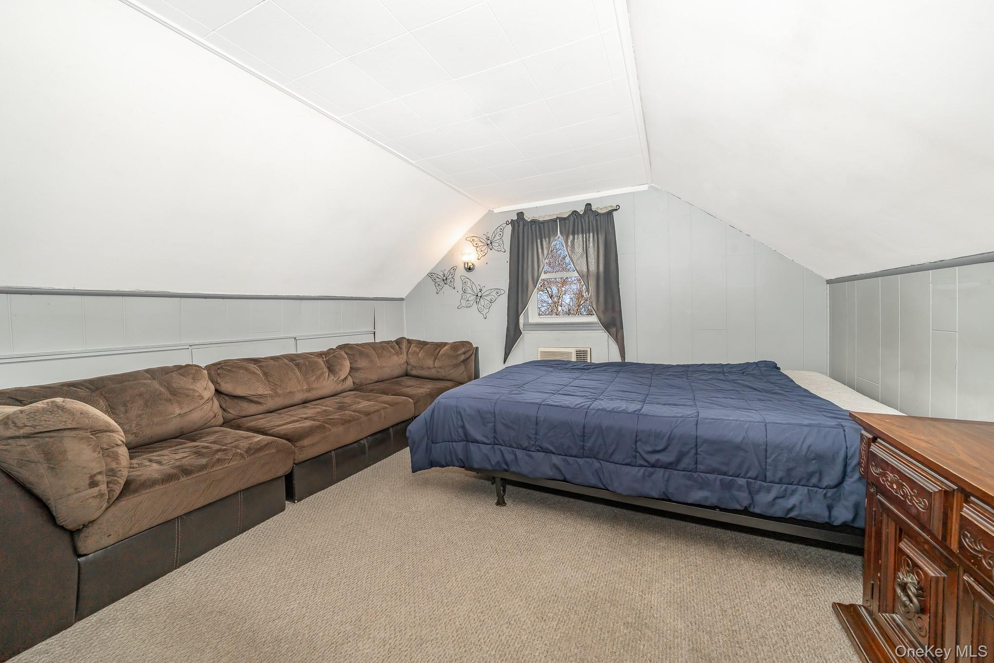 3683 Hawk Road Levittown, NY 11756 - Photo 20 of 41 a bedroom with a bed couch and window