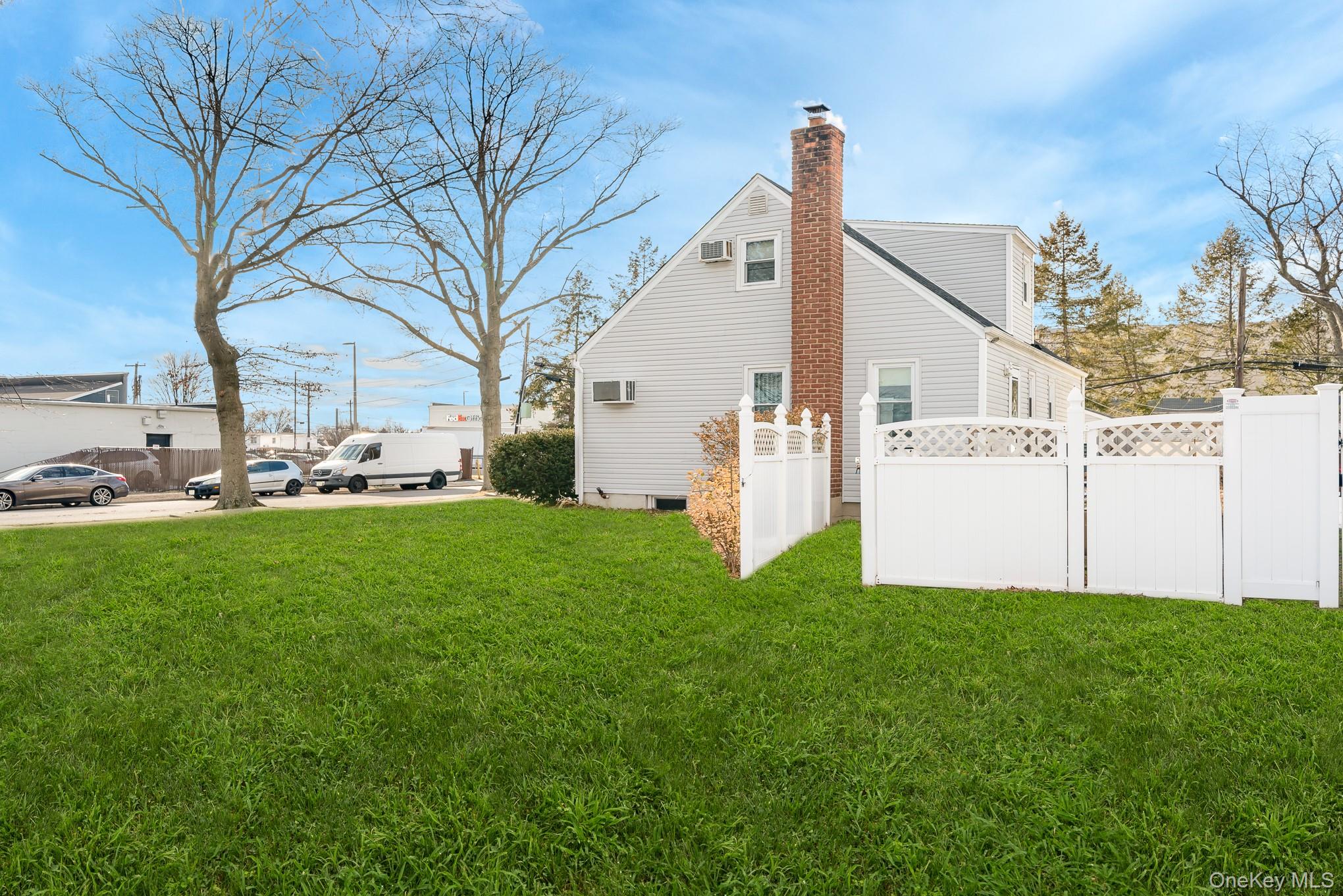 3683 Hawk Road Levittown, NY 11756 - Photo 4 of 41 a front view of a house with a yard and trees