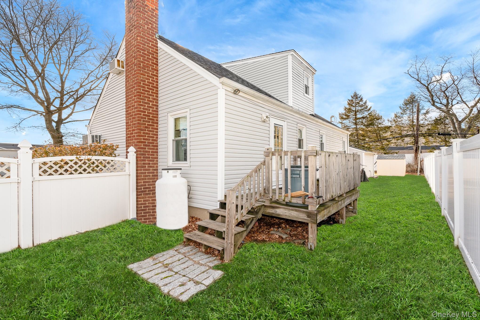 3683 Hawk Road Levittown, NY 11756 - Photo 5 of 41 a backyard of a house with table and chairs