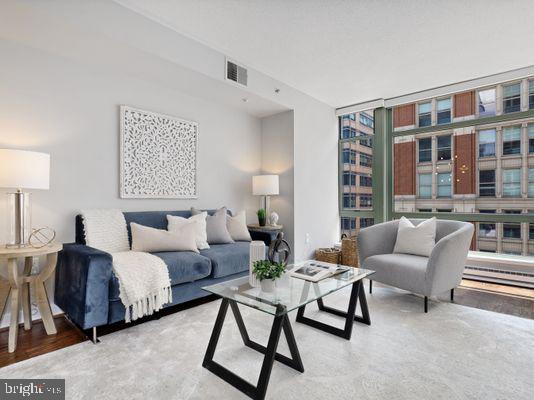1150 K Street Northwest, Unit 709 Washington, DC 20005 - Photo 7 of 25 a living room with furniture and a large window
