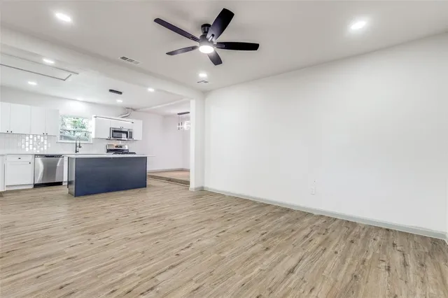 a view of a kitchen with a sink and cabinet