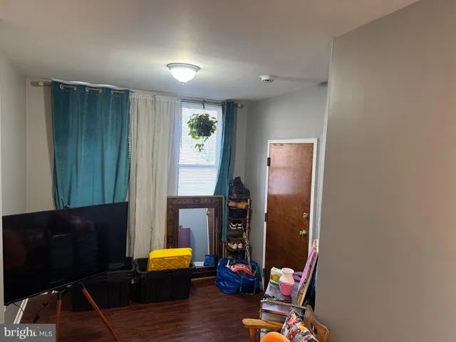 a view of living room with furniture and wooden floor