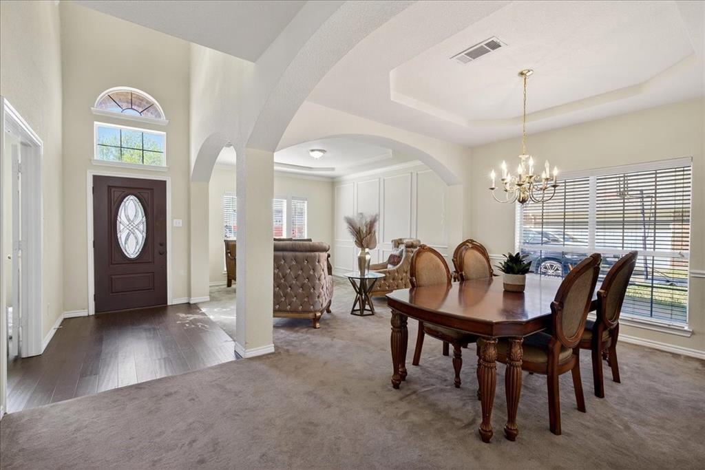 7308 Hawk Lane Sachse, TX 75048 - Photo 6 of 37 a view of a dining room with furniture and chandelier