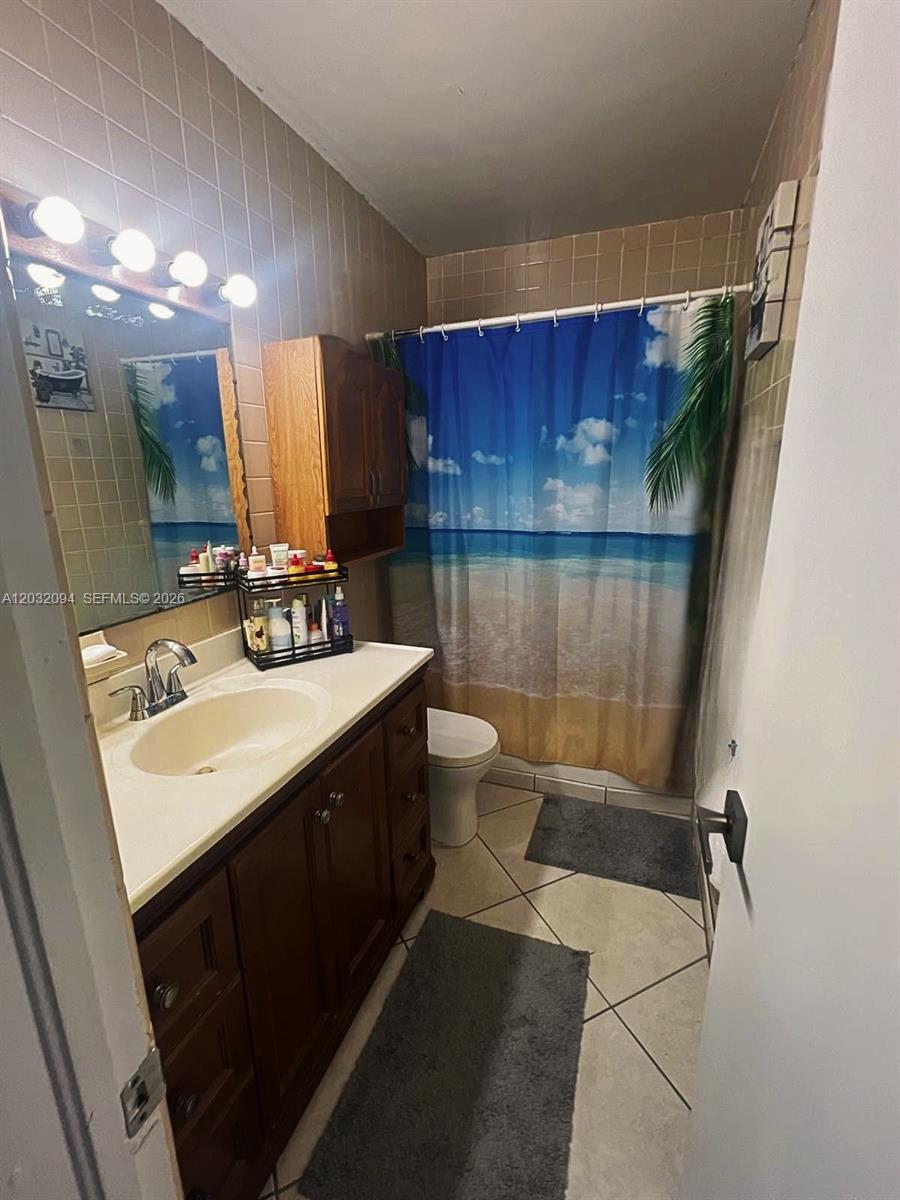 6492 Southwest 25th Street Miramar, FL 33023 - Photo 6 of 9 a bathroom with a sink toilet and shower