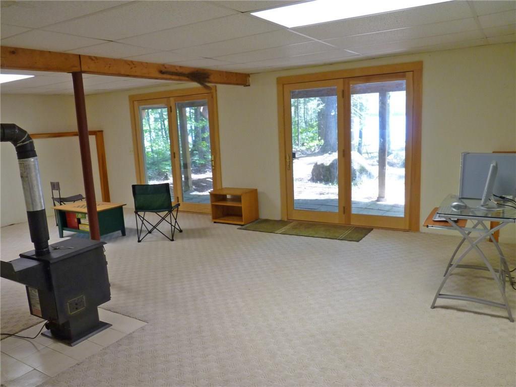 75 Brooks And Dunn Road Otis, ME 04605 - Photo 25 of 35 Family room with heat stove and...