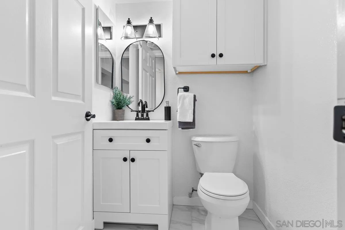 981 North Vulcan Avenue, Unit 4 Encinitas, CA 92024 - Photo 12 of 24 a bathroom with a sink toilet and mirror