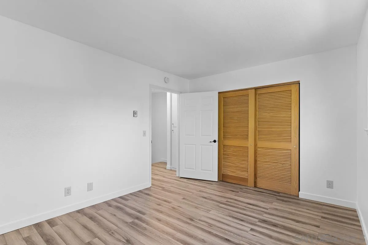 981 North Vulcan Avenue, Unit 4 Encinitas, CA 92024 - Photo 14 of 24 a view of an empty room with wooden floor and closet