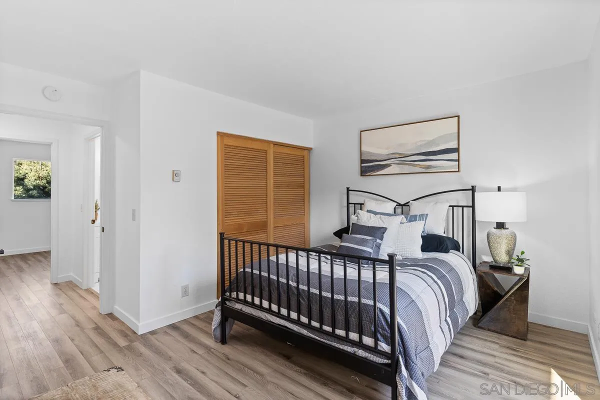 981 North Vulcan Avenue, Unit 4 Encinitas, CA 92024 - Photo 18 of 24 a bedroom with a bed and wooden floor