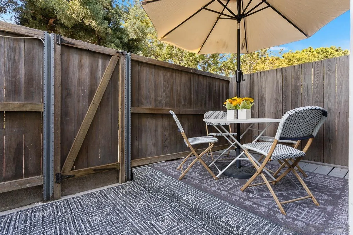 981 North Vulcan Avenue, Unit 4 Encinitas, CA 92024 - Photo 20 of 24 a patio table and chairs under an umbrella
