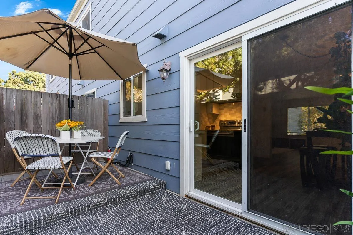 981 North Vulcan Avenue, Unit 4 Encinitas, CA 92024 - Photo 21 of 24 a view of a dining room with a table and chairs under an umbrella