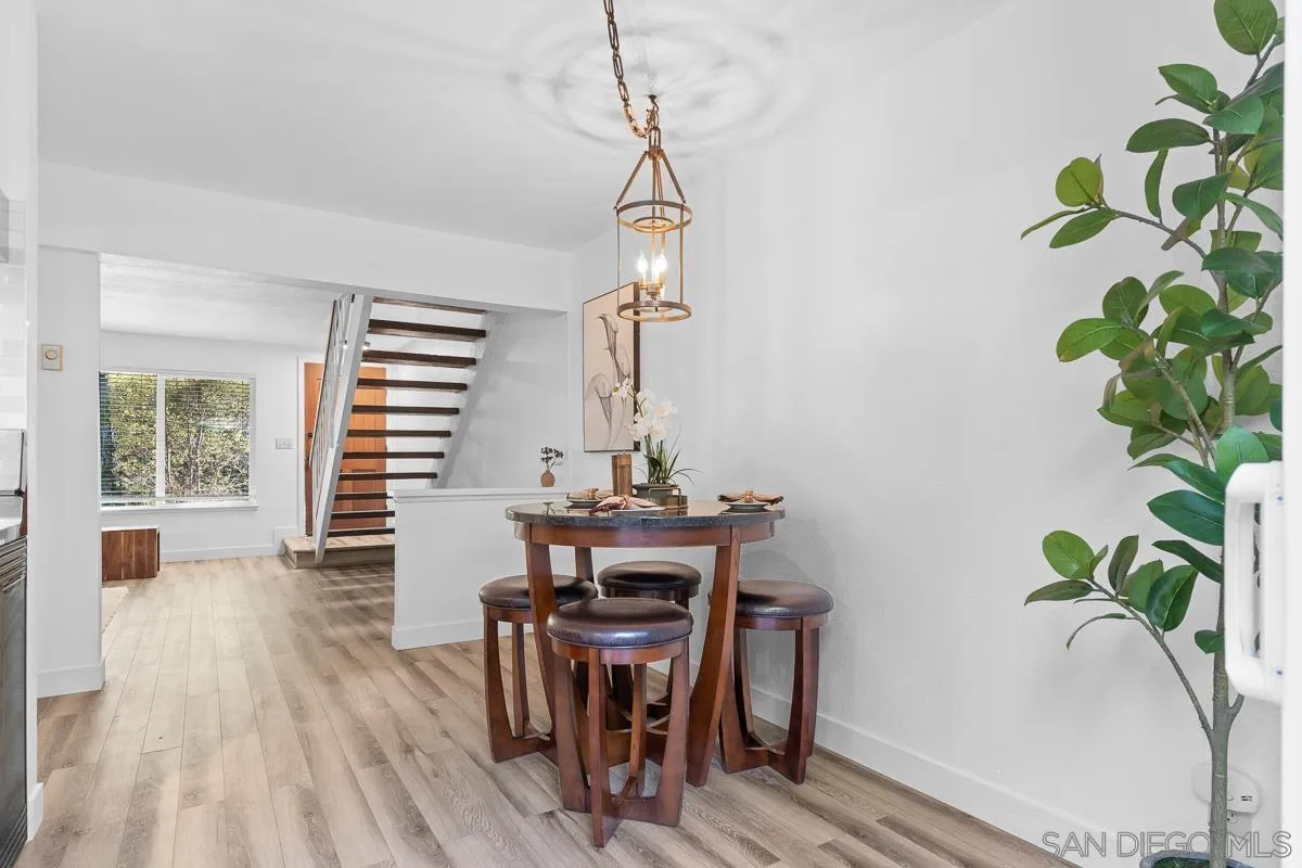 981 North Vulcan Avenue, Unit 4 Encinitas, CA 92024 - Photo 7 of 24 a view of a dining room with furniture window and wooden floor