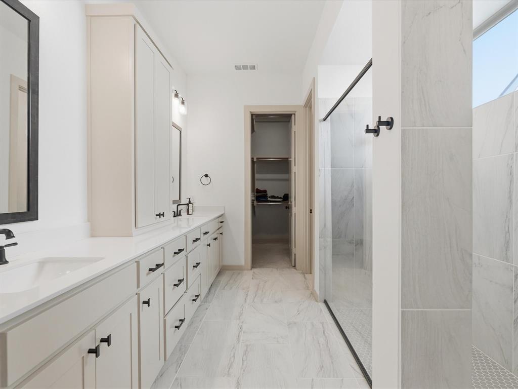 9533 Keep Street Frisco, TX 75035 - Photo 19 of 40 Bathroom featuring a dual vanity with white cabinetry and black hardware