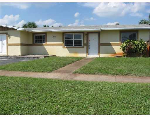 6301 Southwest 3rd Street Pompano Beach, FL 33068 - Photo 1 of 13 a front view of house with yard
