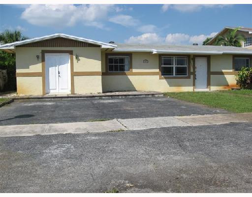 6301 Southwest 3rd Street Pompano Beach, FL 33068 - Photo 2 of 13 a front view of a house with a yard and garage