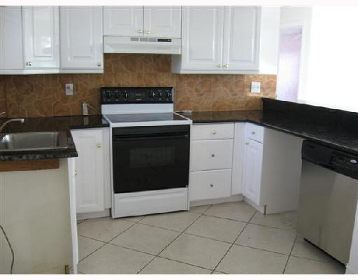 6301 Southwest 3rd Street Pompano Beach, FL 33068 - Photo 7 of 13 a kitchen with cabinets and appliances