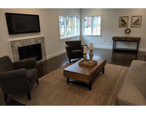 60 Woodcliff Road Brookline, MA 02467 - Photo 5 of 30 a living room with furniture a flat screen tv and a fireplace