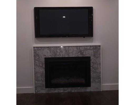60 Woodcliff Road Brookline, MA 02467 - Photo 7 of 30 a living room with a fireplace and a fireplace
